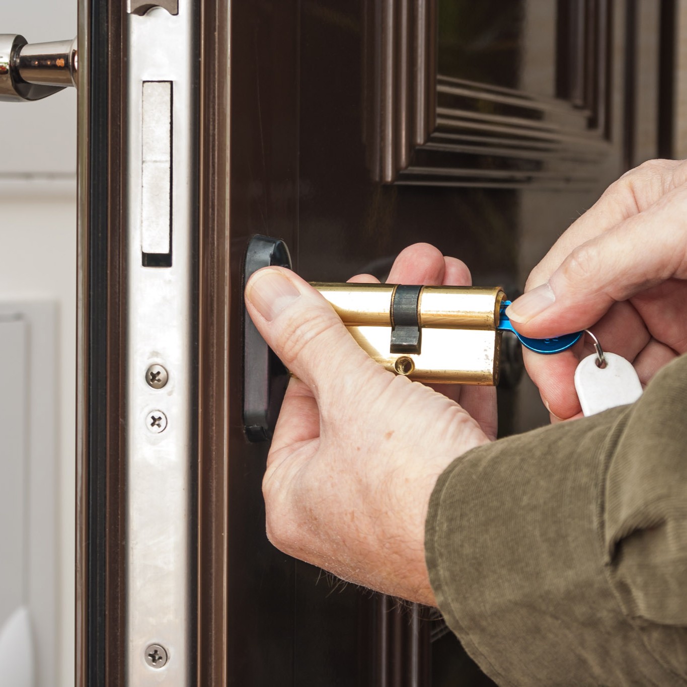 Locksmith repairing the lock on a business door